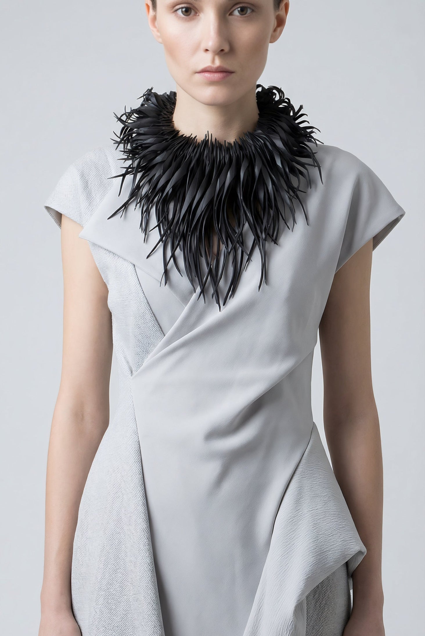 model wears bold,curly,  large black statement necklace made out of recycled upcycled bike tyre rubber inner tube by Laura Zabo, bib necklace