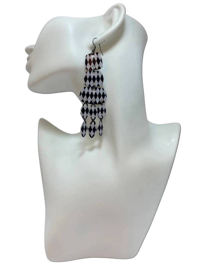 black and white upcycled chandelier earrings made from nespresso capsules on a white mannequin and background