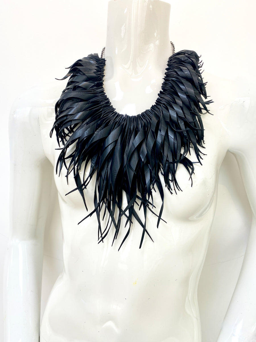 chunky, black large curly tassel necklace made from upcycled bicycle tyre inner tube on a white mannequin