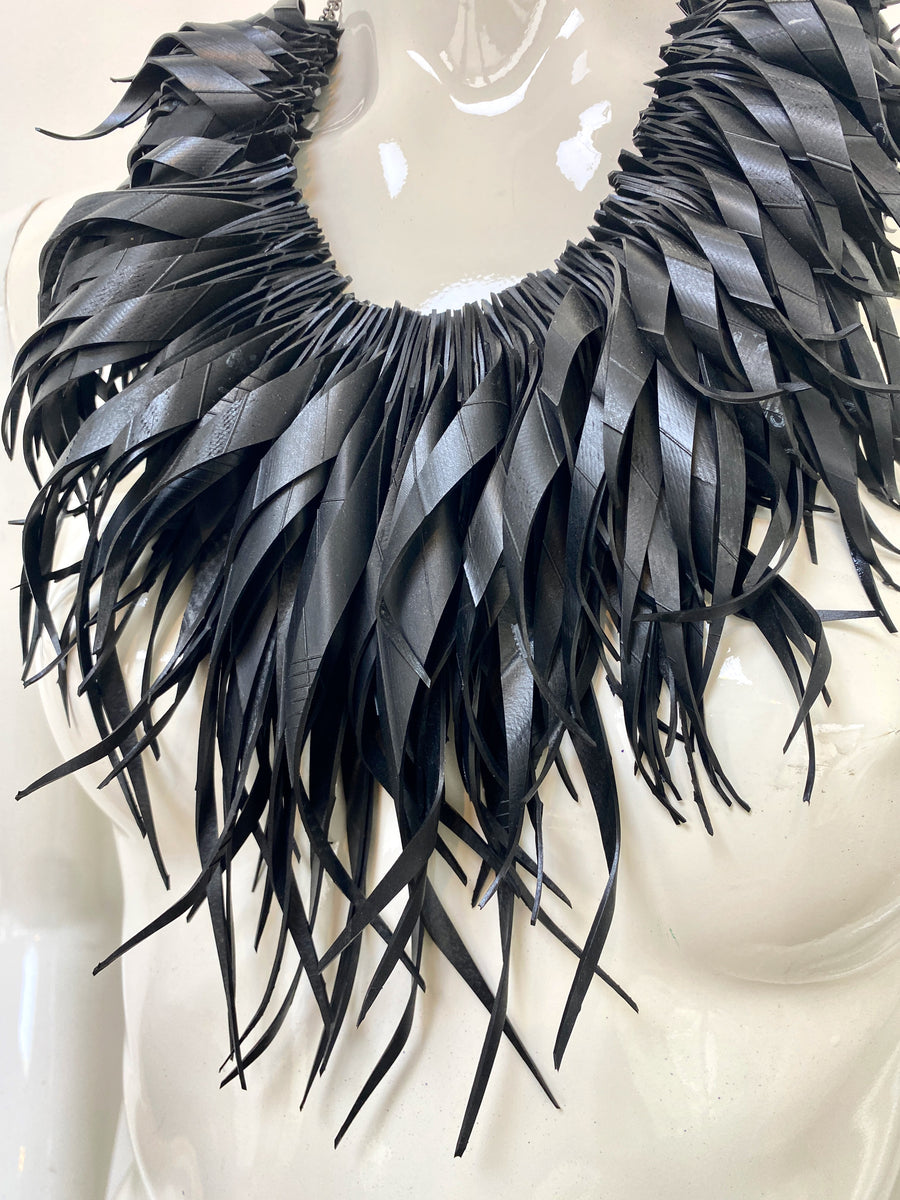 chunky, black large curly tassel necklace made from upcycled bicycle tyre inner tube on a white mannequin