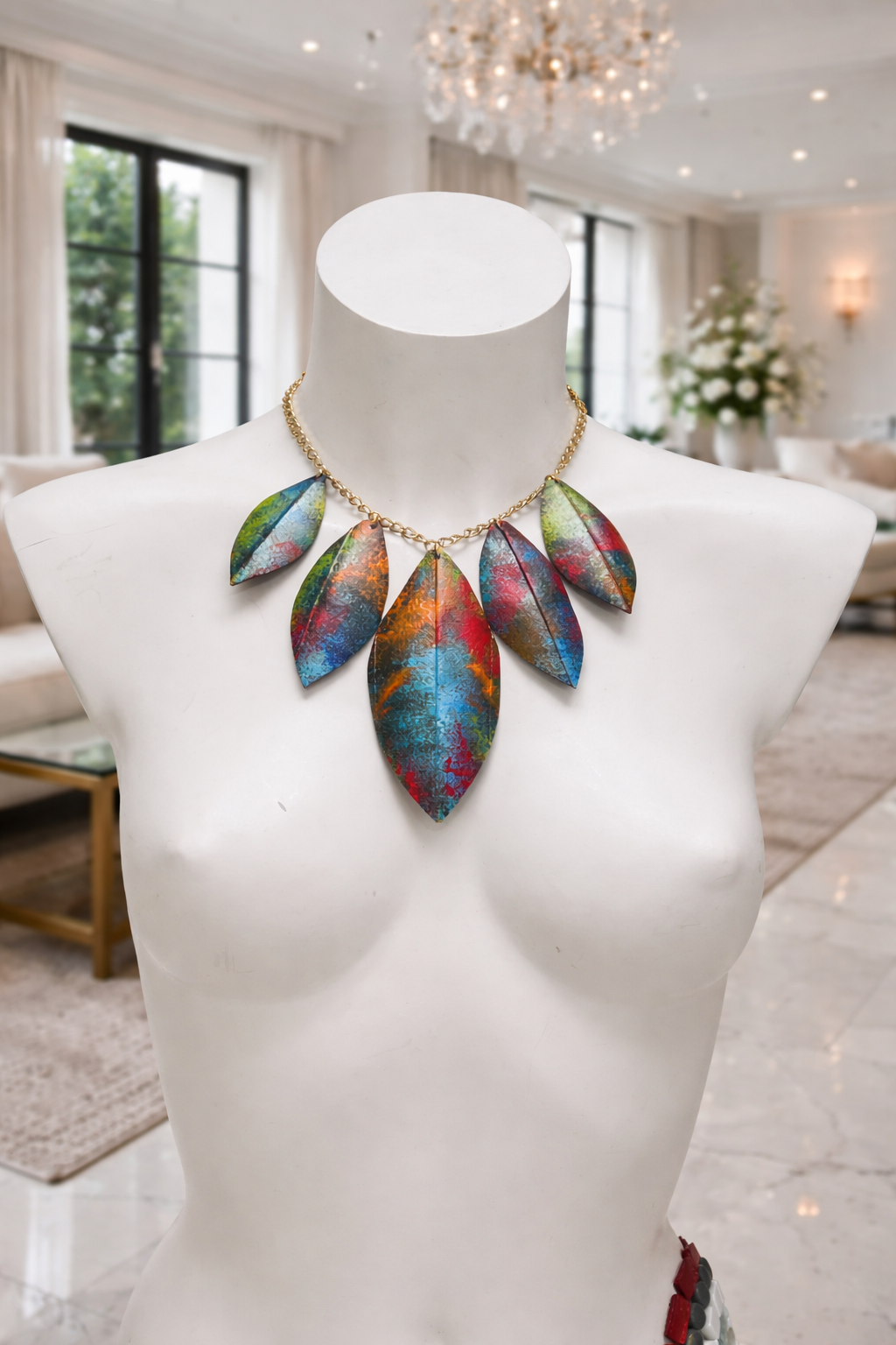 Colorful necklace made from upcycled bicycle inner tube rubber on a mannequin bust in a room with decor elements.