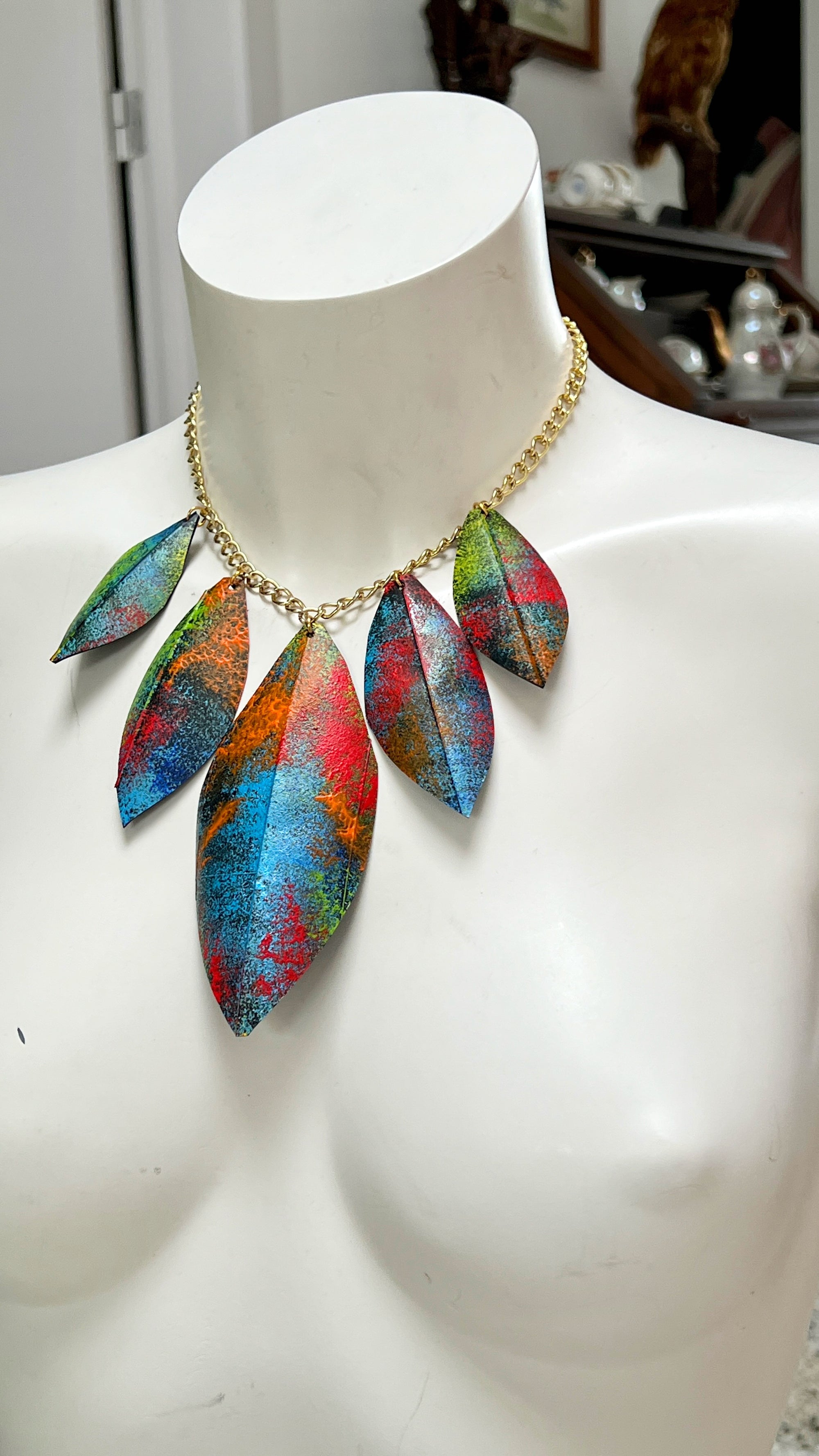 Colorful leaf-shaped necklace made from upcycled bicycle inner tube rubber on a mannequin