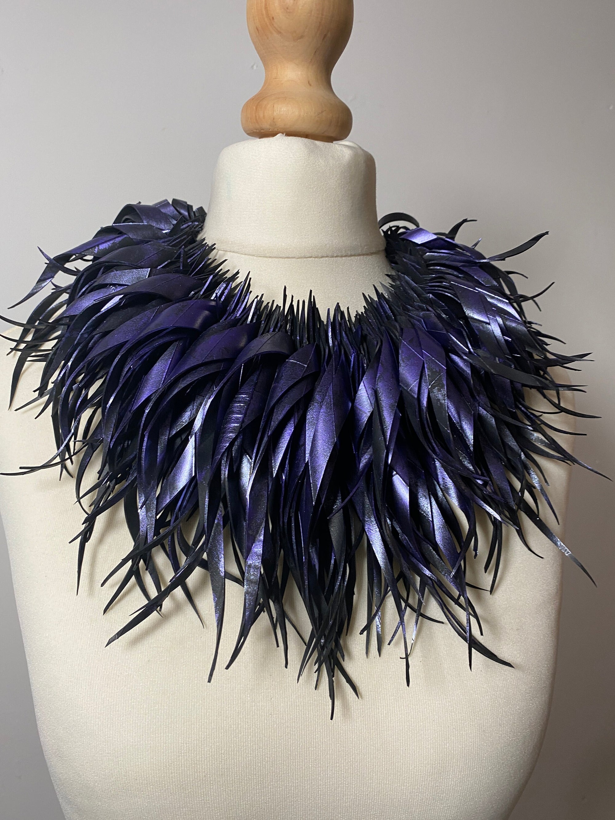 metallic purple, curly tassel necklace, chunky collar made from upcycled bicycle tyre rubber by laura zabo on a white mannequin