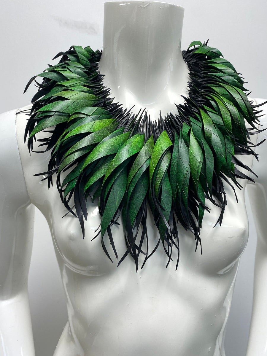 Green statement necklace, upcycled bicycle inner tube jewelry on a white mannequin