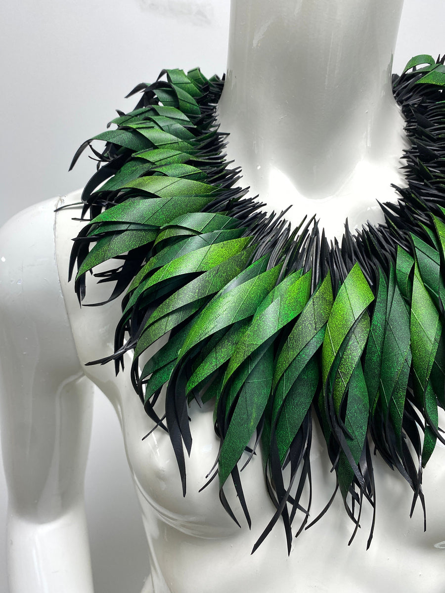 Green statement necklace, upcycled bicycle inner tube jewelry on a white mannequin