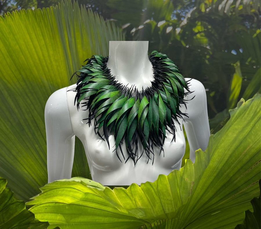 Green statement necklace, upcycled bicycle inner tube jewelry on a white mannequin