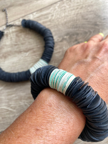 model wears black white African tribal necklace made from upcycled bicycle inner tubes, tyre rubber and paper circles