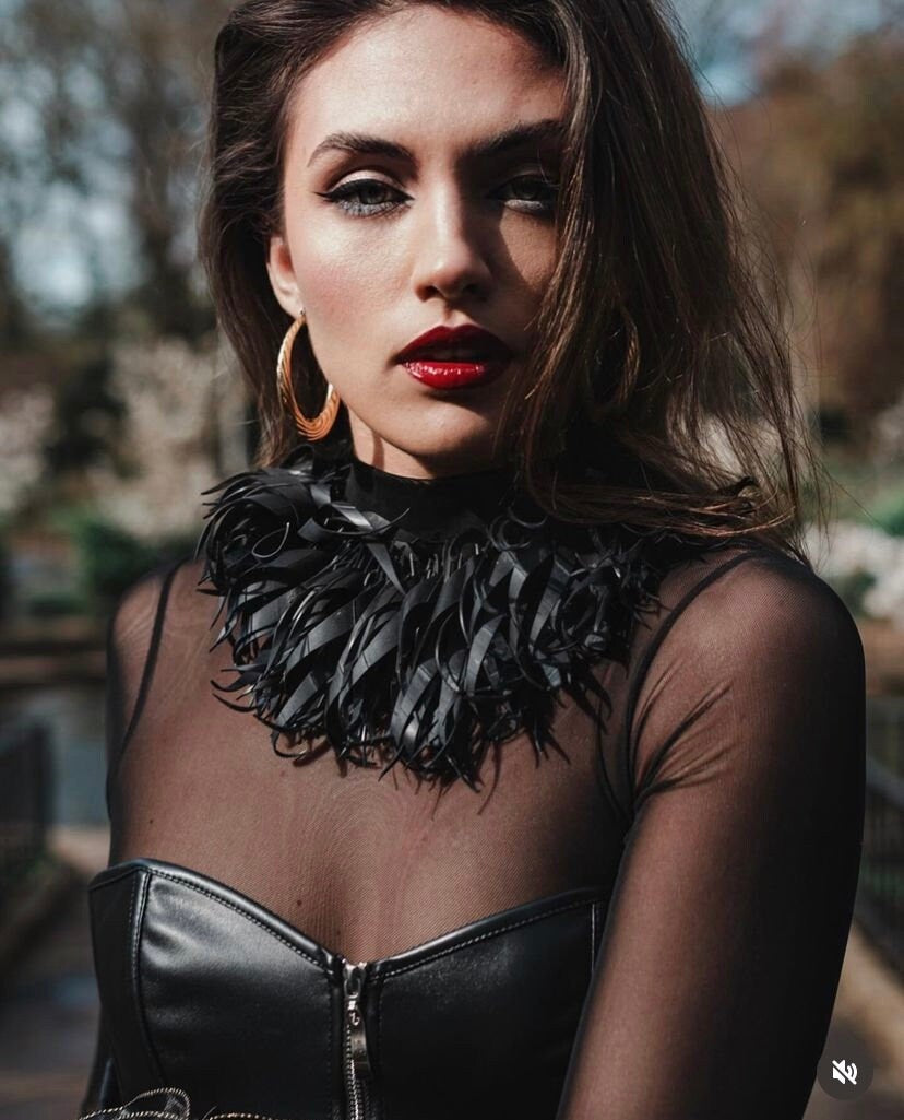 model wears large, chunky black tassel necklace made from upcycled bicycle inner tube