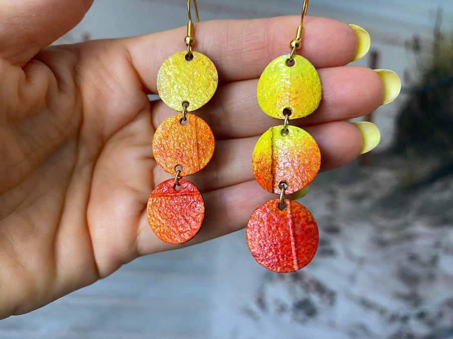 Sunrise themed earrings, in orange-yellow colours, made from upcycled bicycle inner tubes