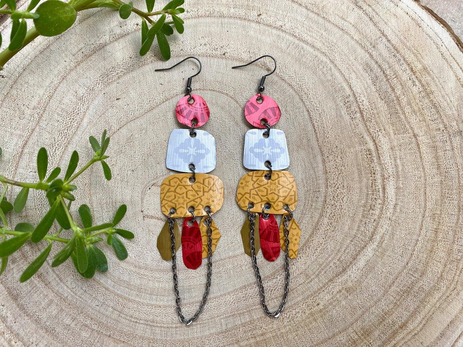 large, bohemian statement earrings made from upcycled Nespresso pods, capsules on a wooden background