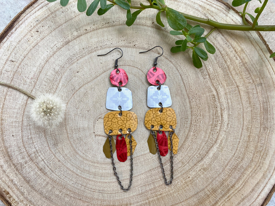 large, bohemian statement earrings made from upcycled Nespresso pods, capsules on a wooden background