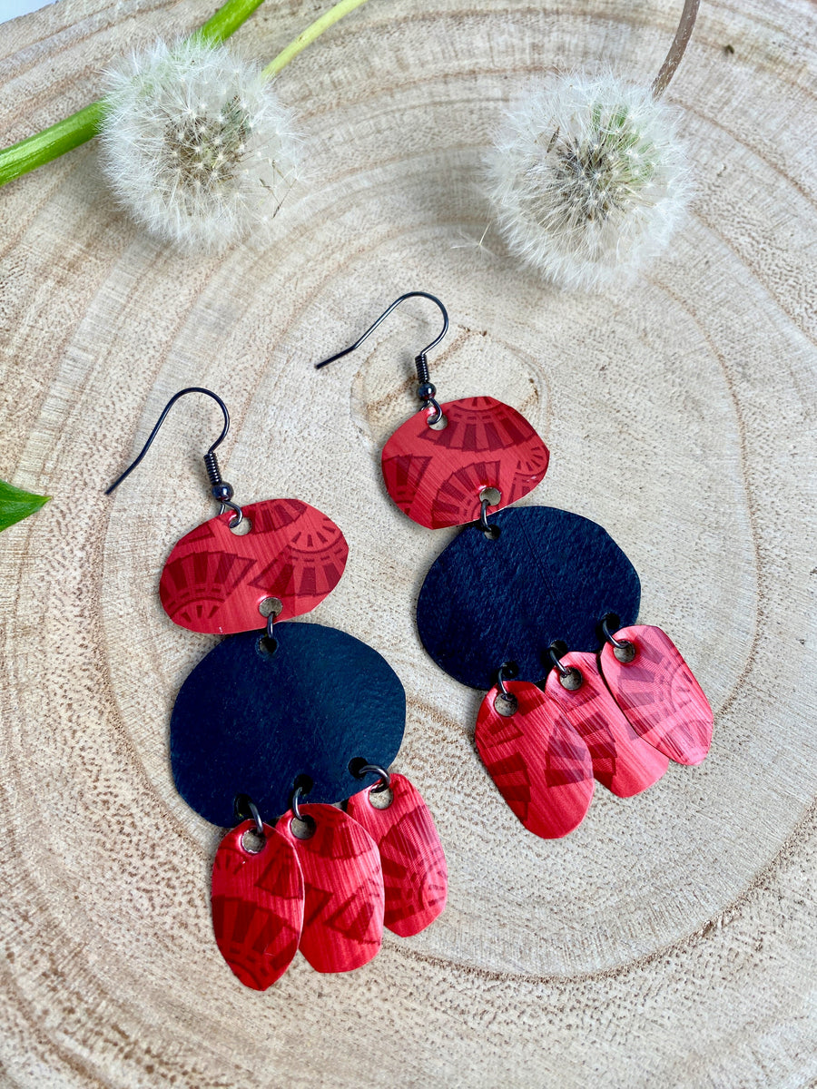 red black bohemian earrings, made from upcycled bicycle inner tubes and Nespresso capsules, on wooden background