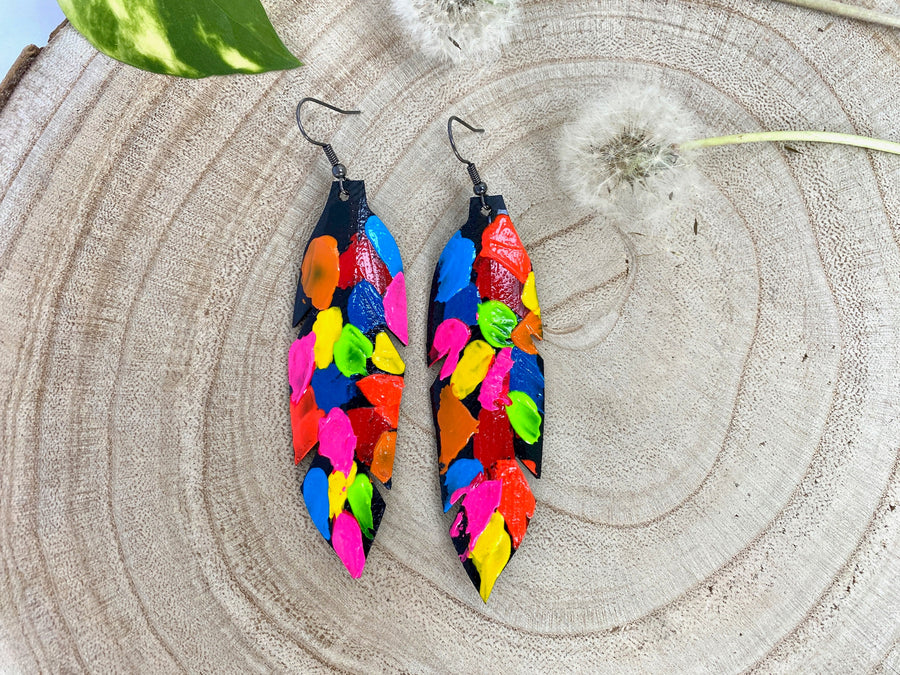 pop art, abstract, neon coloured leaf shaped earrings made from upcycled bicycle inner tube rubber on a wooden background