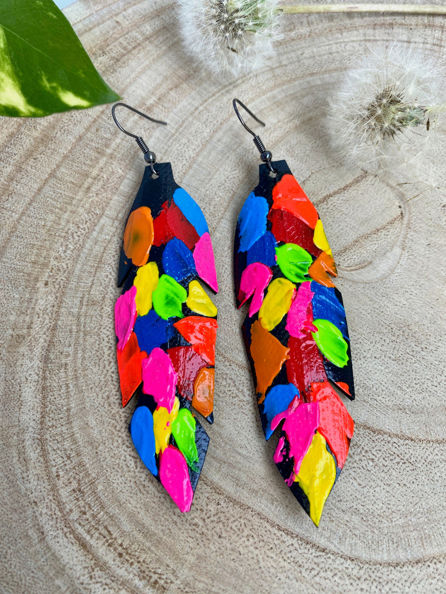 pop art, abstract, neon coloured leaf shaped earrings made from upcycled bicycle inner tube rubber on a wooden background