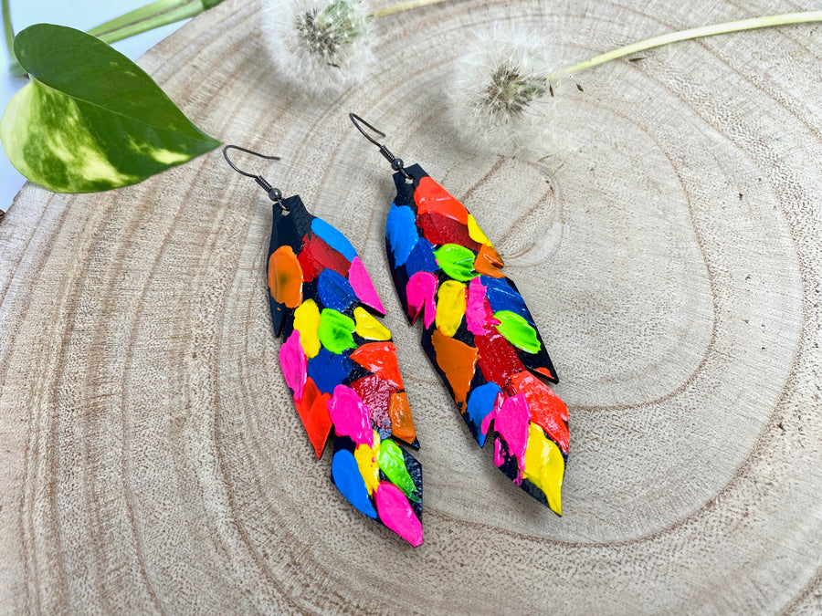 pop art, abstract, neon coloured leaf shaped earrings made from upcycled bicycle inner tube rubber on a wooden background