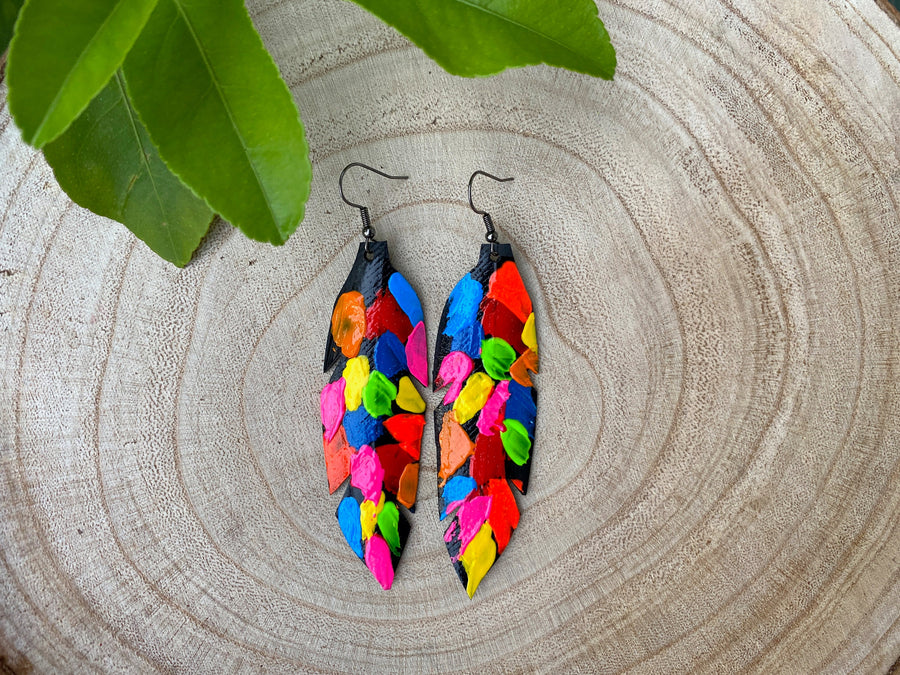 pop art, abstract, neon coloured leaf shaped earrings made from upcycled bicycle inner tube rubber on a wooden background