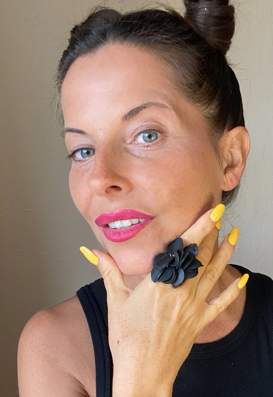 model wears black upcycled rubber, bicycle tube flower shaped statement ring