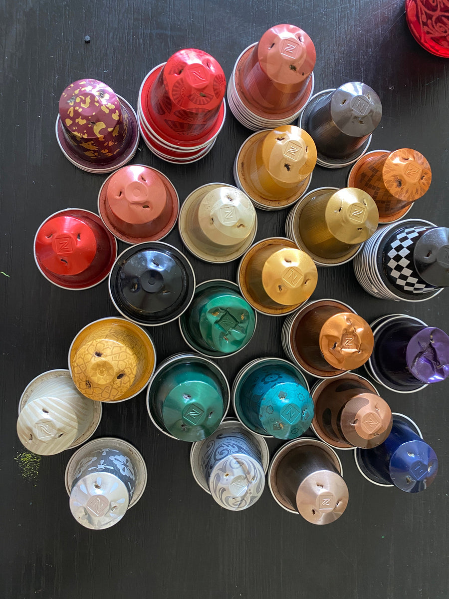 used colourful nespressp pods on a black background