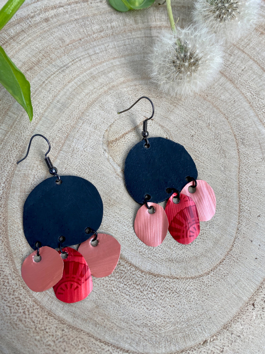 black red peach coloured upcycled nespresso capsules and bike inner tube rubber earrings on a wooden background