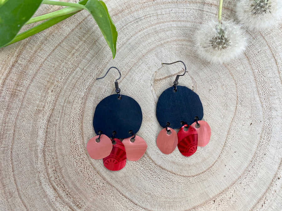 black red peach coloured upcycled nespresso capsules and bike inner tube rubber earrings on a wooden background