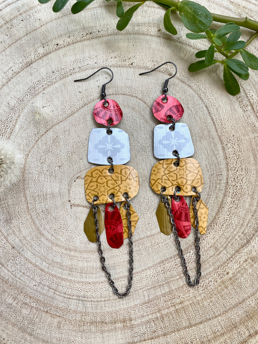 large, bohemian statement earrings made from upcycled Nespresso pods, capsules on a wooden background