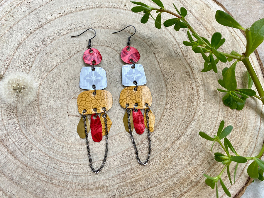 large, bohemian statement earrings made from upcycled Nespresso pods, capsules on a wooden background