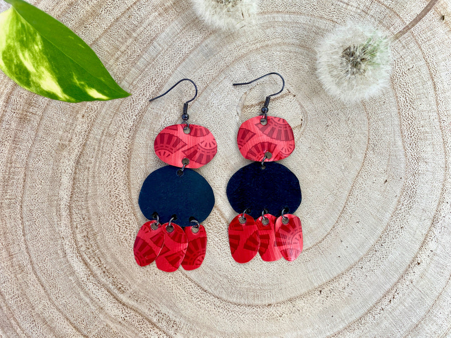 red black bohemian earrings, made from upcycled bicycle inner tubes and Nespresso capsules, on wooden background