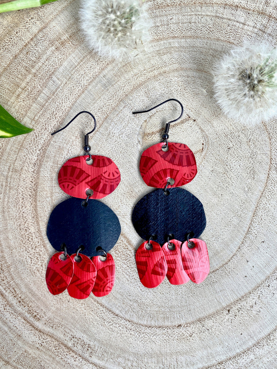 red black bohemian earrings, made from upcycled bicycle inner tubes and Nespresso capsules, on wooden background