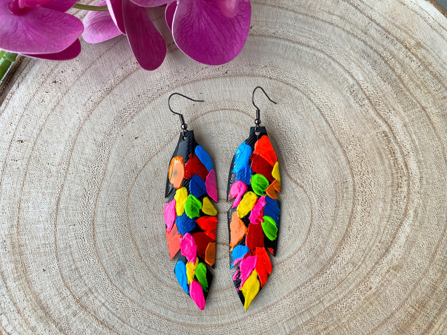 pop art, abstract, neon coloured leaf shaped earrings made from upcycled bicycle inner tube rubber on a wooden background