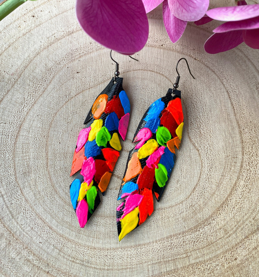 pop art, abstract, neon coloured leaf shaped earrings made from upcycled bicycle inner tube rubber on a wooden background