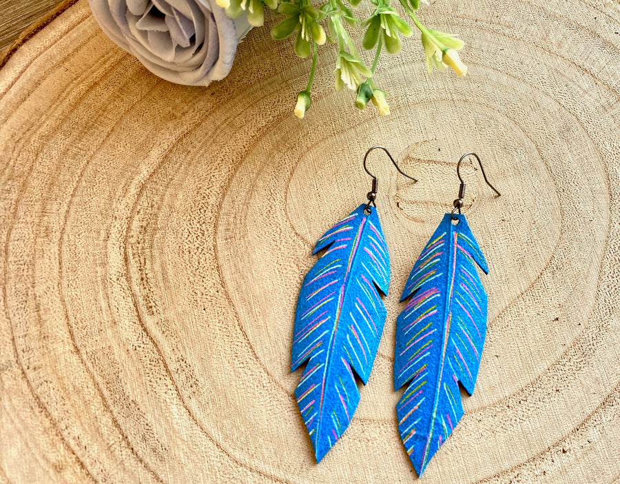 blue coloured leaf shaped, upcycled bicycle inner tube, rubber earrings on a wooden background