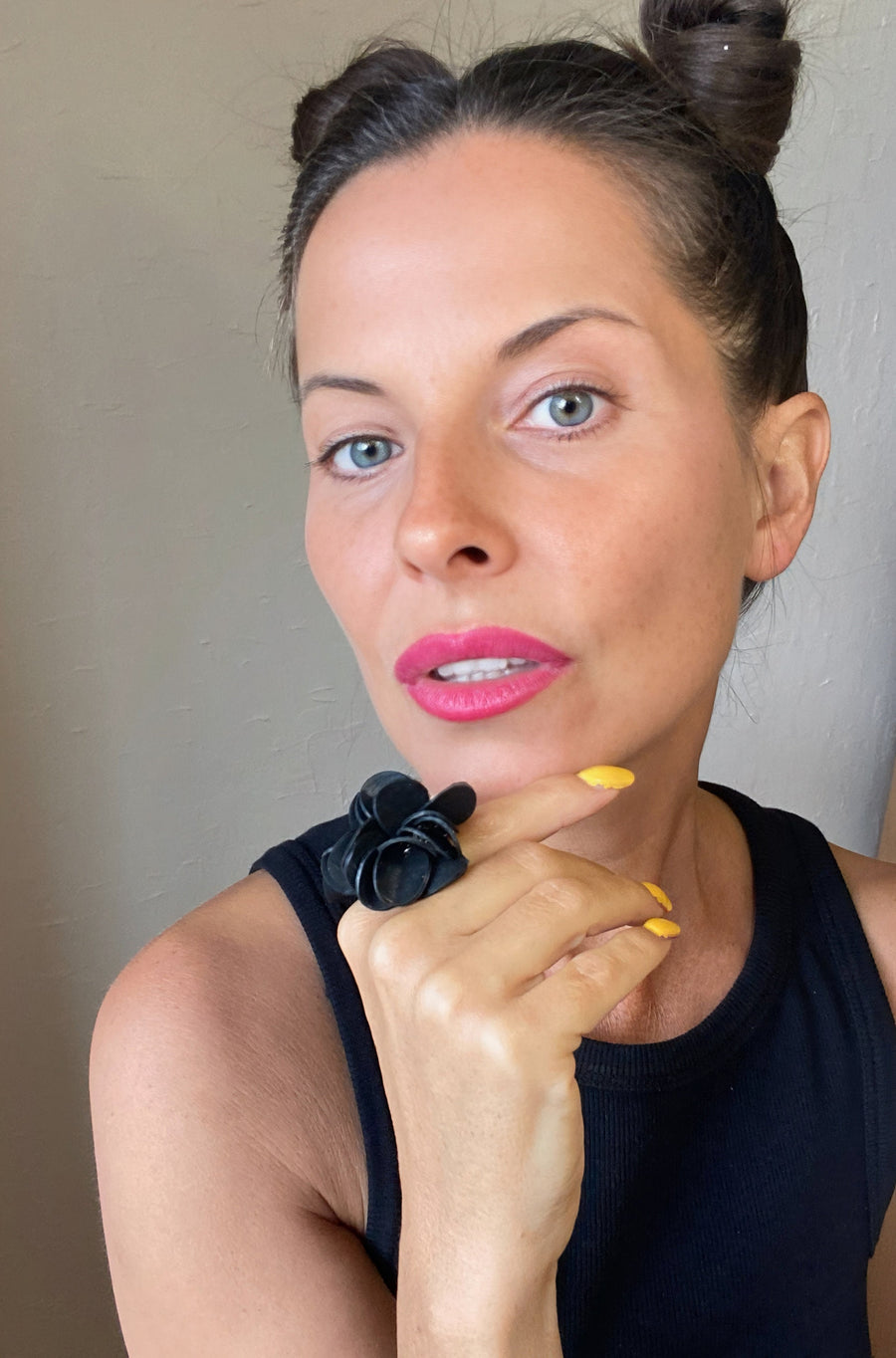 model wears black upcycled rubber, bicycle tube flower shaped statement ring