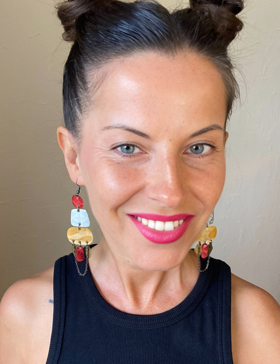 model wears red silver and gold bohemian statement earrings made from upcycled Nespresso, coffee pods