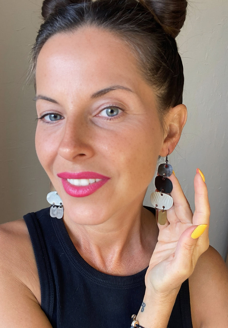 Laura Zabo wears bold, upcycled Nespresso capsules, pod earrings, oriental designs