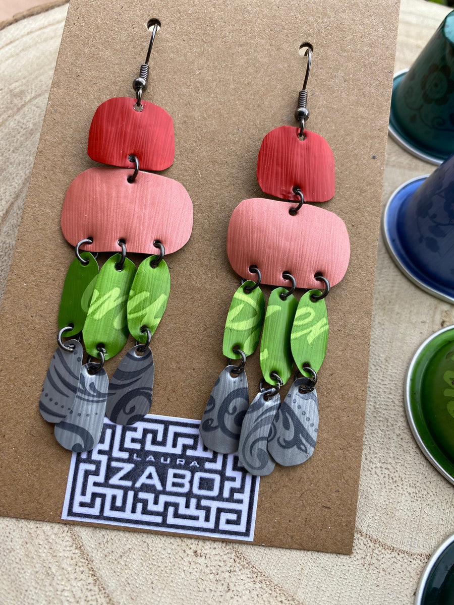 colourful oriental design earrings in red, peach, green and grey colour made from upcycled nespresso capsules on a wooden background and with few whole nespresso pods