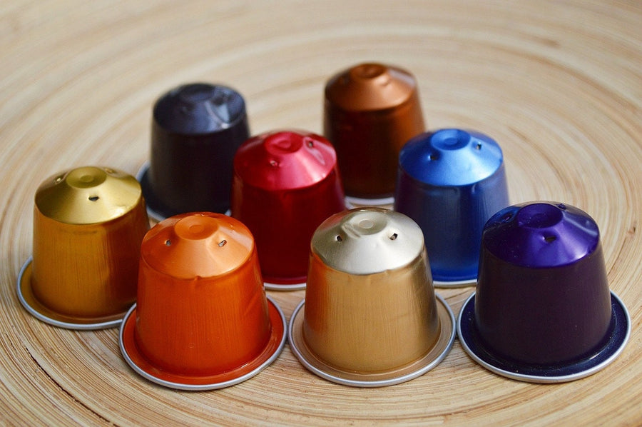 some used nespresso pods on a wooden background