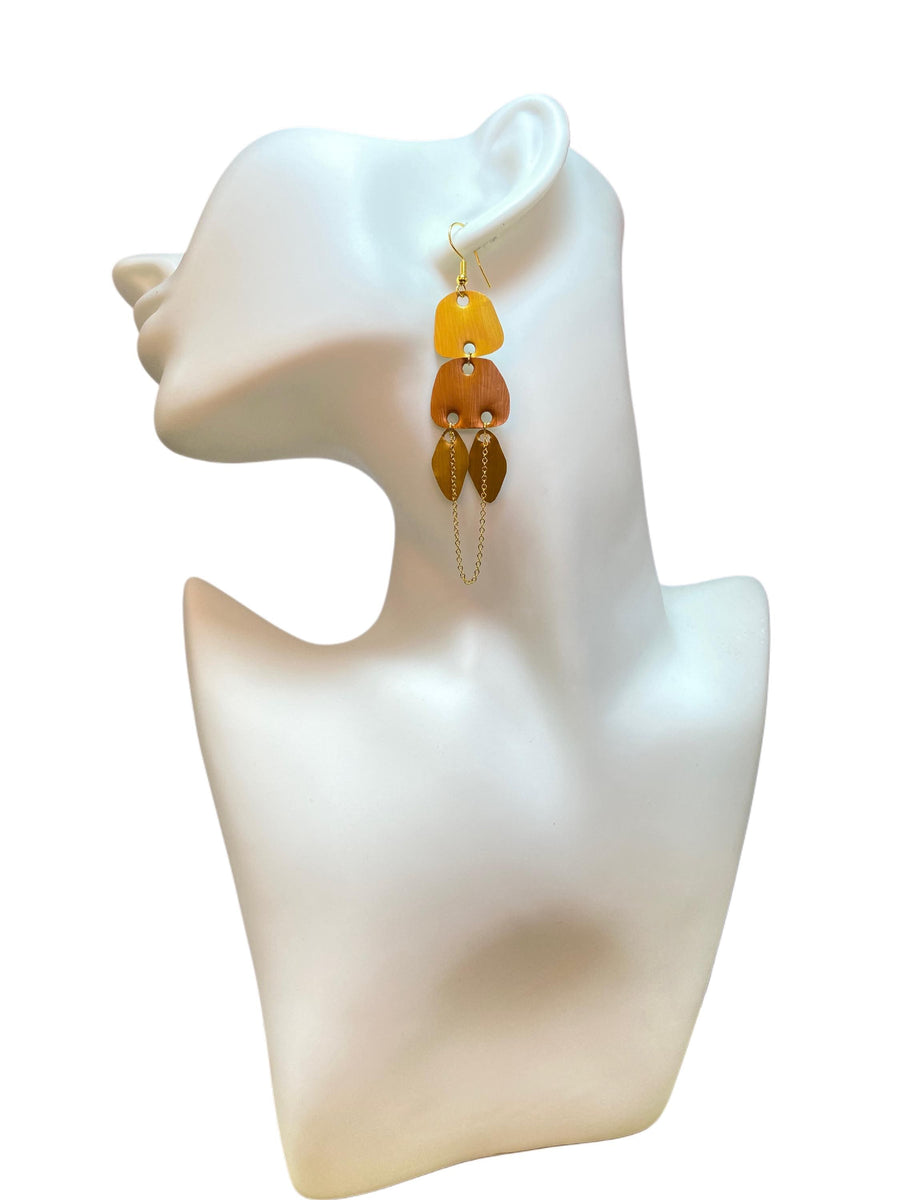 gold, copper, bronze upcycled nespresso capsules earrings on a white mannequin and white backgroun