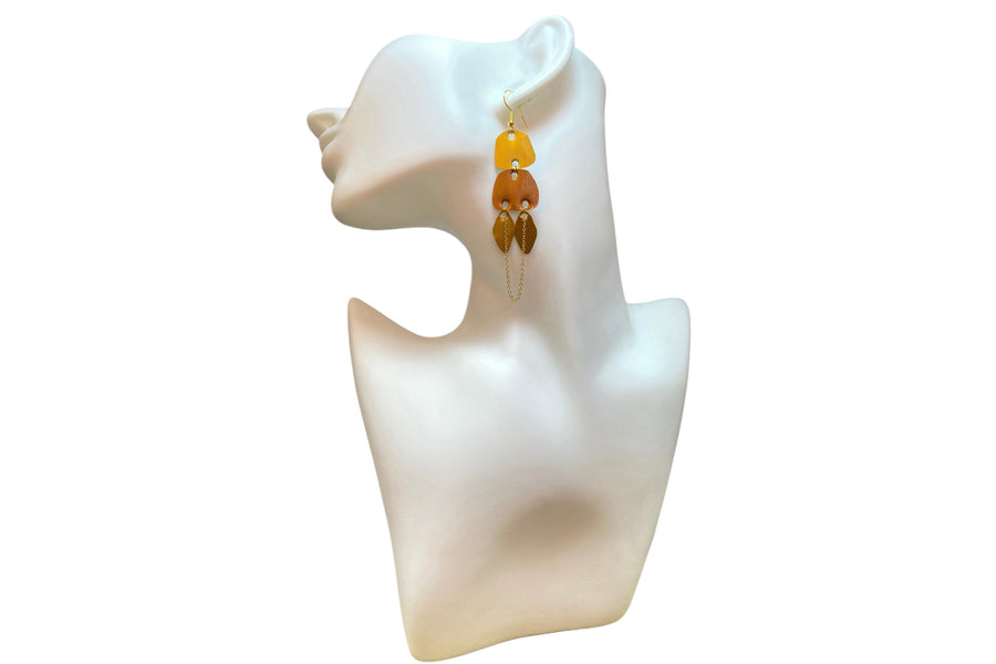 gold, copper, bronze upcycled nespresso capsules earrings on a white mannequin and white backgroun