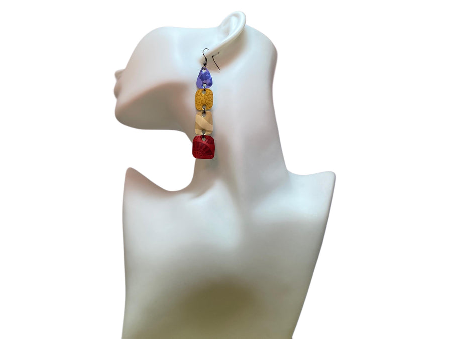 blue, brown, red, colourful earrings made from upcycled nespresso pods on awhite mannequin and background