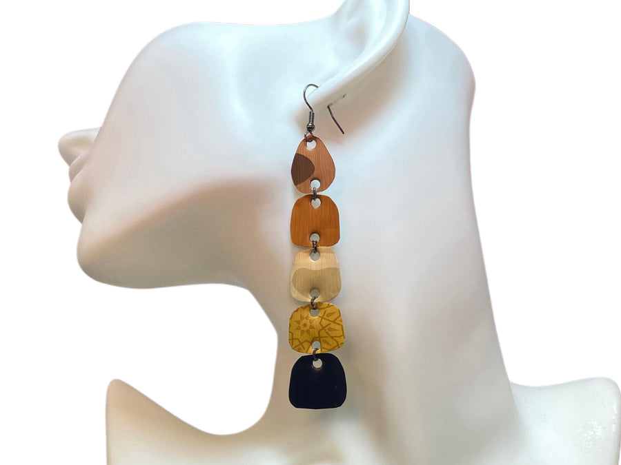 earthy coloured, brown black gold long earrings made from upcycled nespresso capsules on white mannequin and white background