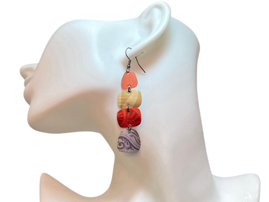 peach, sand, red, silver earrings made from upcycled nespresso capsules on a white mannequin and white background