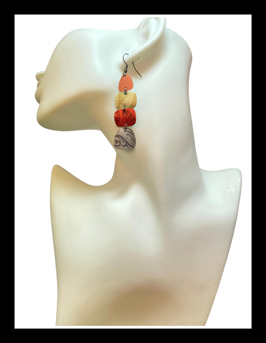 peach, sand, red, silver earrings made from upcycled nespresso capsules on a white mannequin and white background