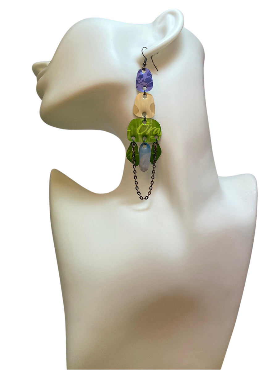 long, oriental, blue, sand, green earrings made from upcycled nespresso capsules on a white mannequin and white background