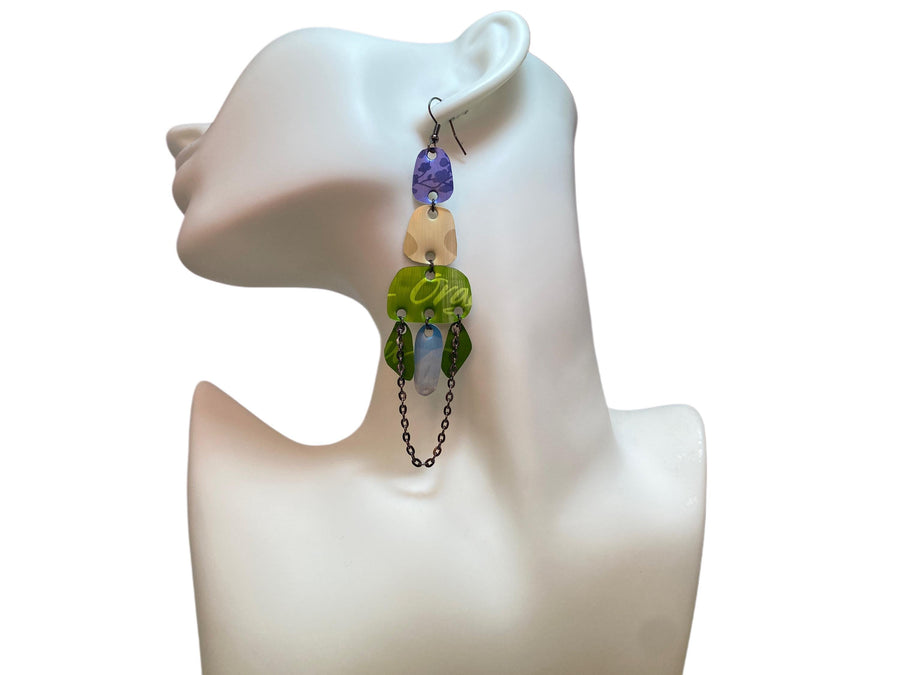 long, oriental, blue, sand, green earrings made from upcycled nespresso capsules on a white mannequin and white background