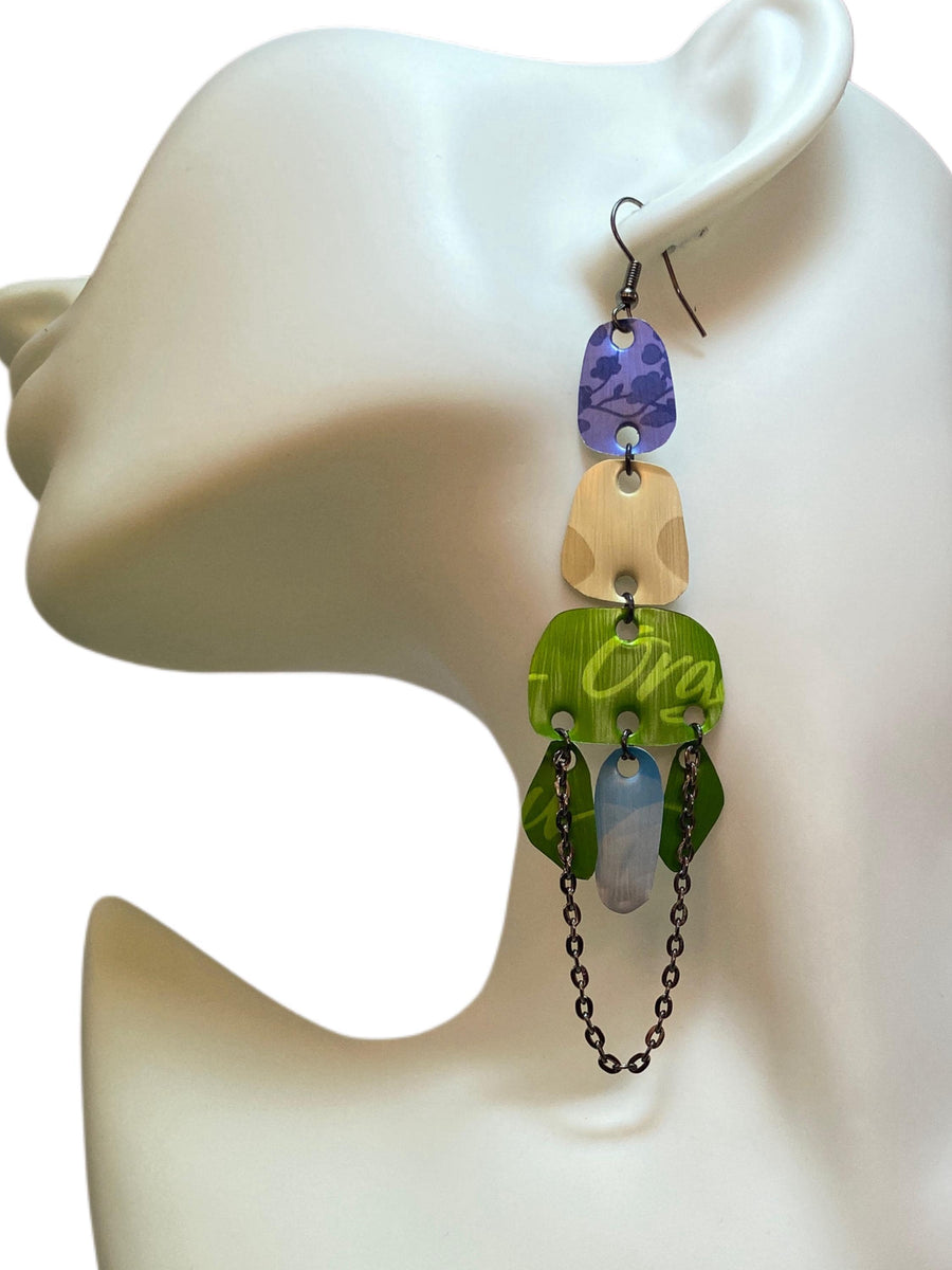 long, oriental, blue, sand, green earrings made from upcycled nespresso capsules on a white mannequin and white background