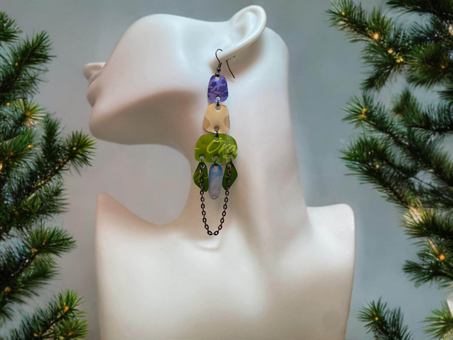 long, oriental, blue, sand, green earrings made from upcycled nespresso capsules on a white mannequin and xmas themed background