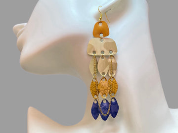 golden sand blue oriental earrings made from upcycled nespresso pods on a white mannequin and grey background