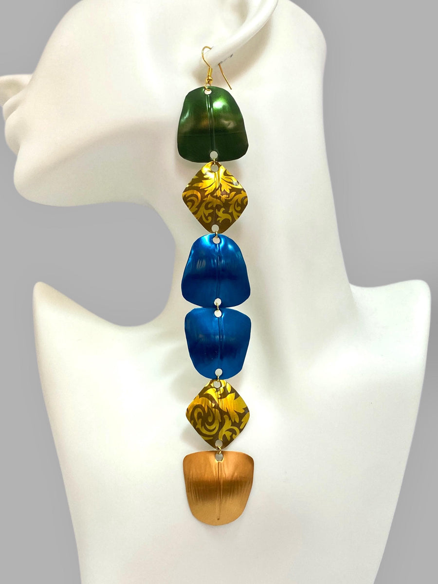 extra long, colourful, green, gold, blue statement earrings made from upcycled nespresso capsules on a white mannequin and grey background