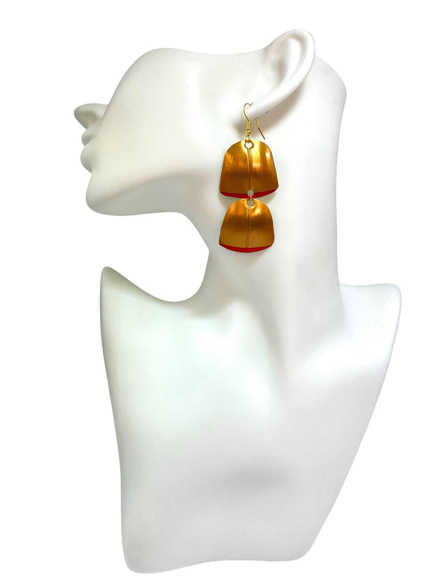 Gold red geometric and asymmetric earring made from upcycled upcycled nespresso capsules on a mannequin and white background