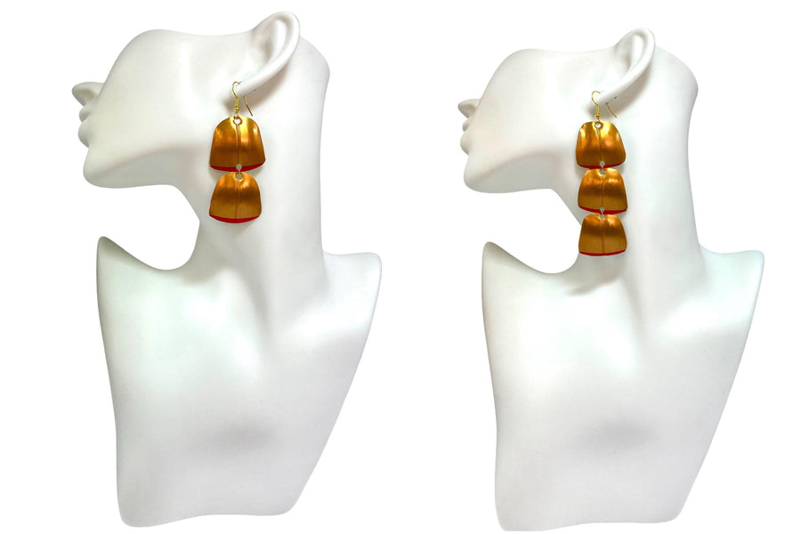 Gold red geometric and asymmetric earrings made from upcycled upcycled nespresso capsules on 2 mannequin and white background